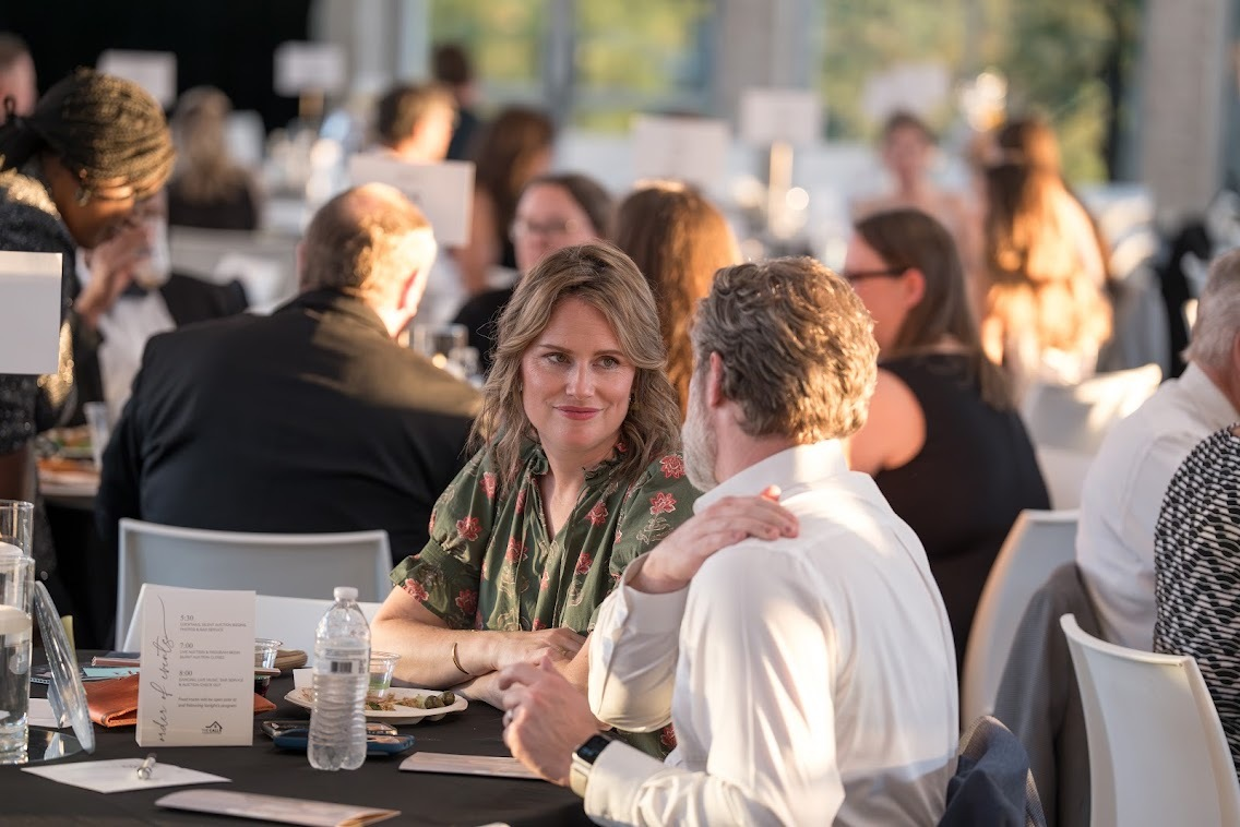 Guests seated at a table during the gala