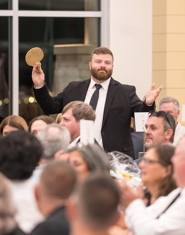 Guest raising a hand during the auction